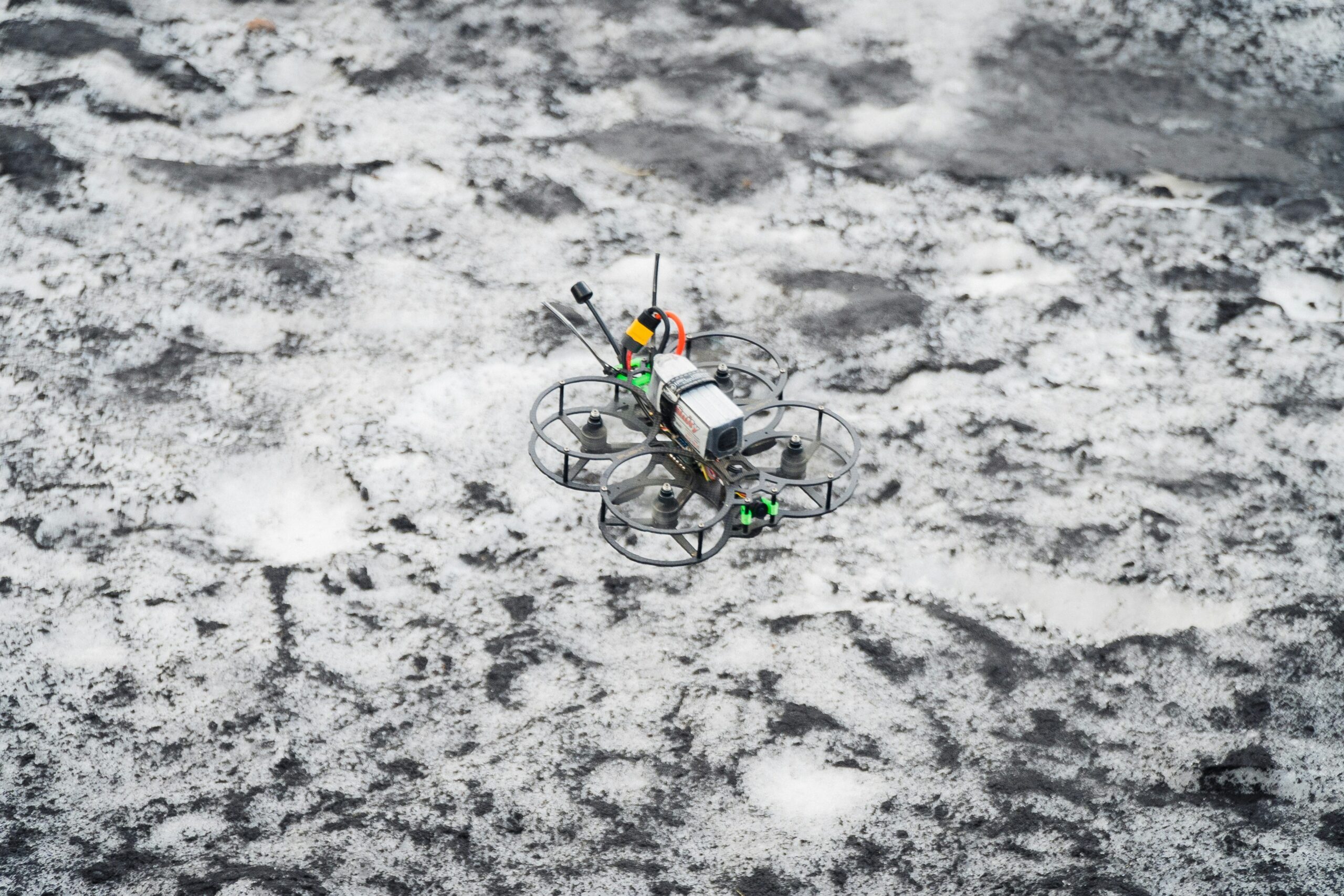 A stranded cyclist sitting by their broken ebike on a muddy trail
