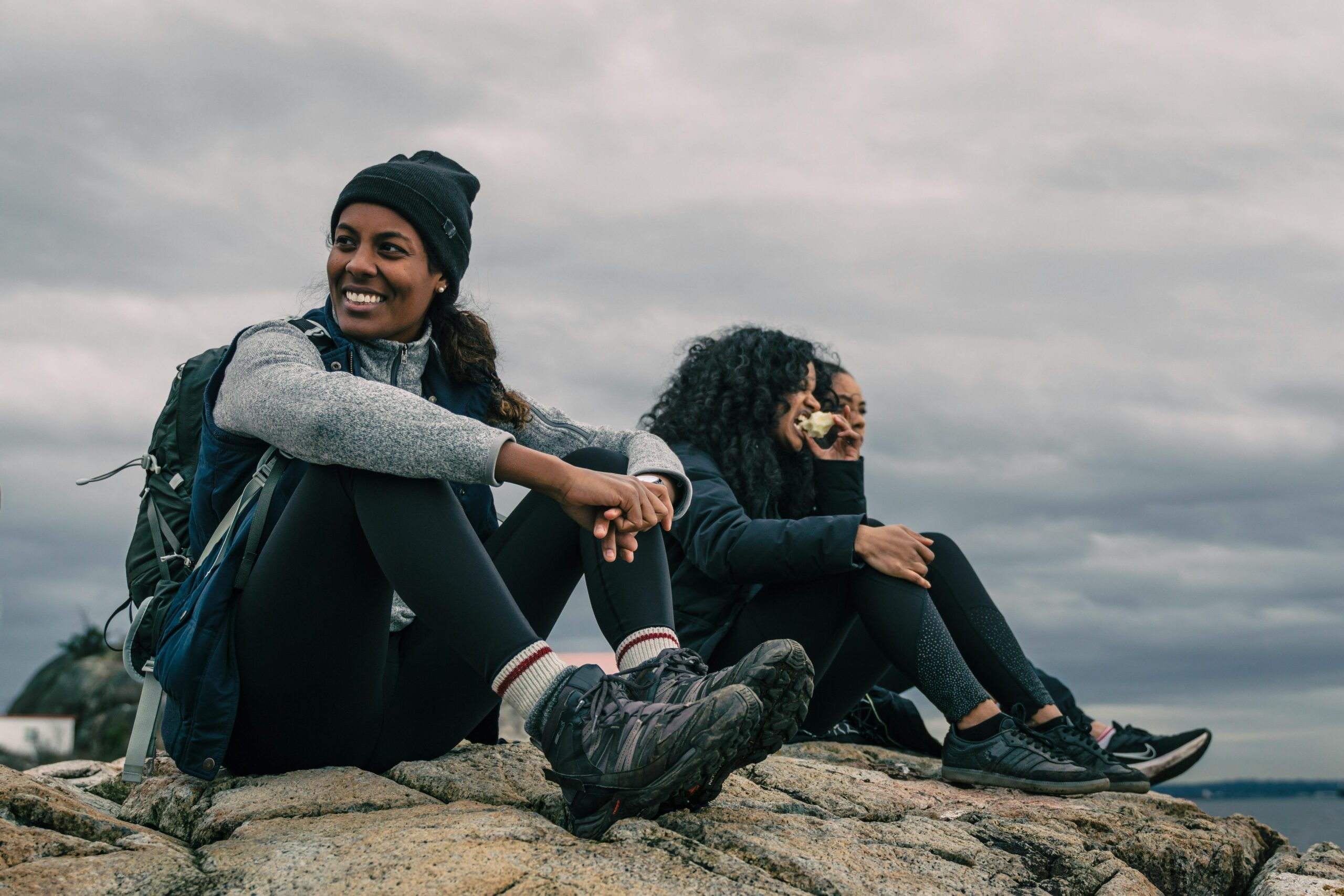 Group of tourists smiling near mountains after e-bike journey