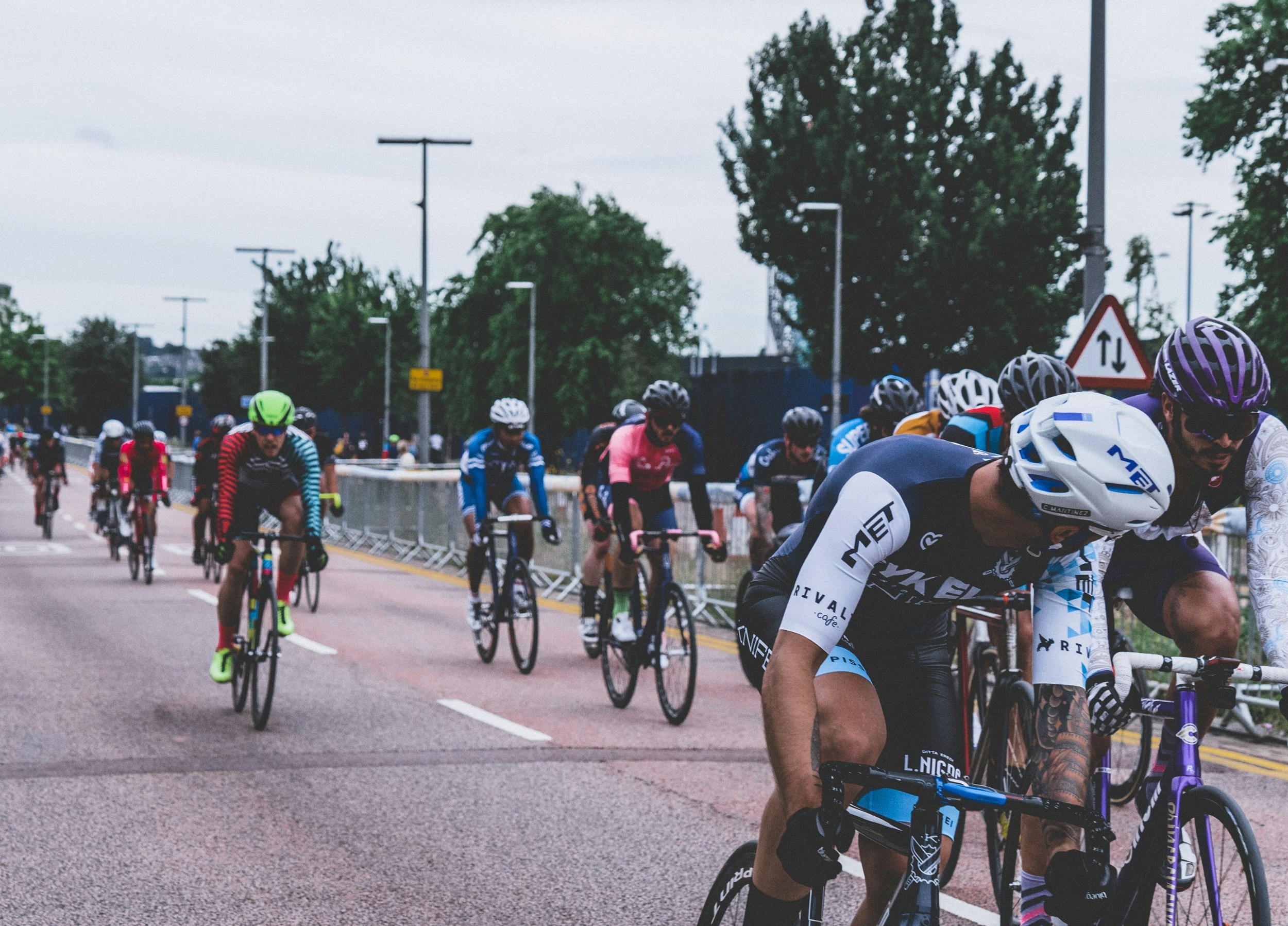 A cheerful gathering of urban cyclists celebrating their finish line at a city event.