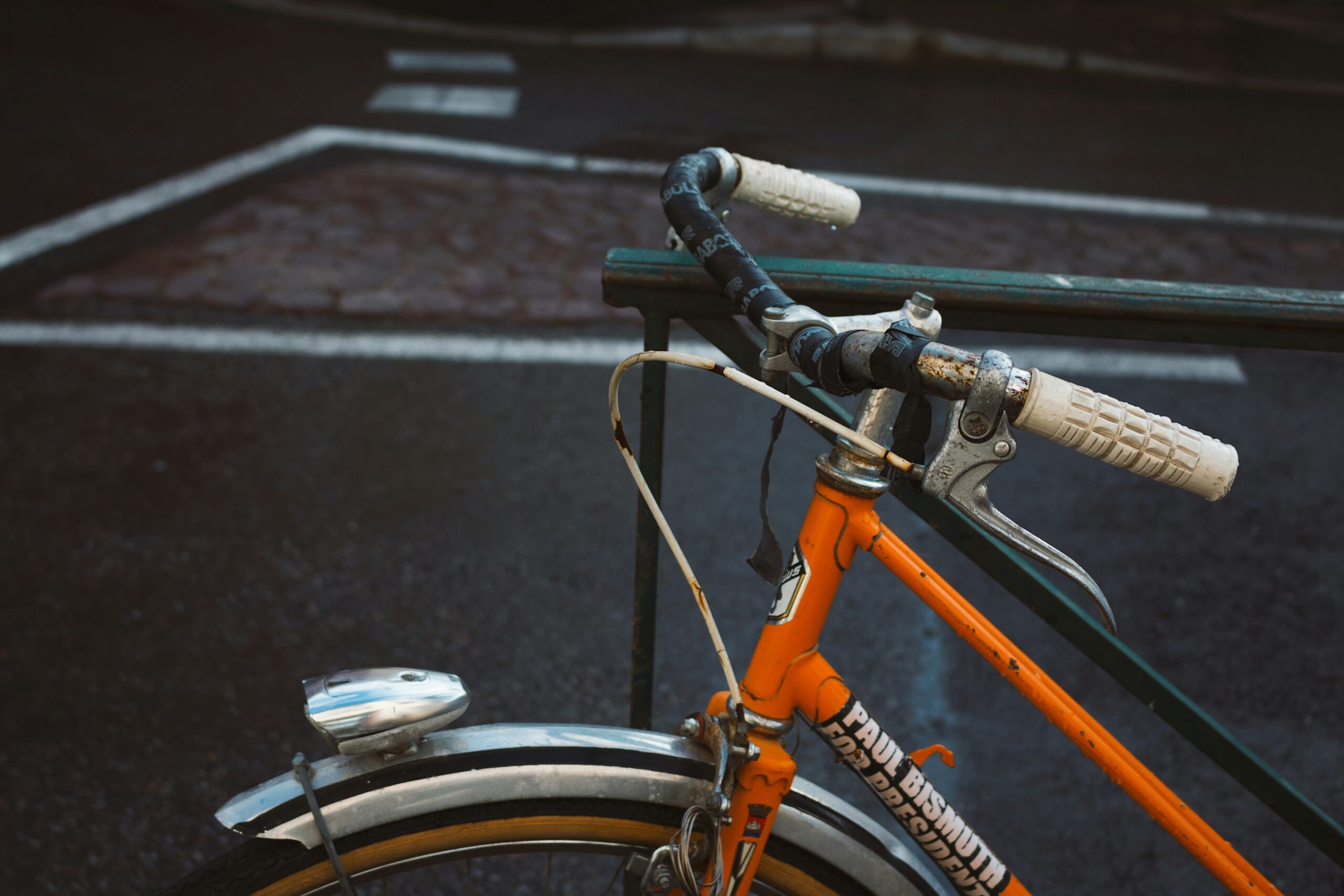 A map spread on a wooden table showing highlighted areas and marked paths for urban exploration using e-bikes.