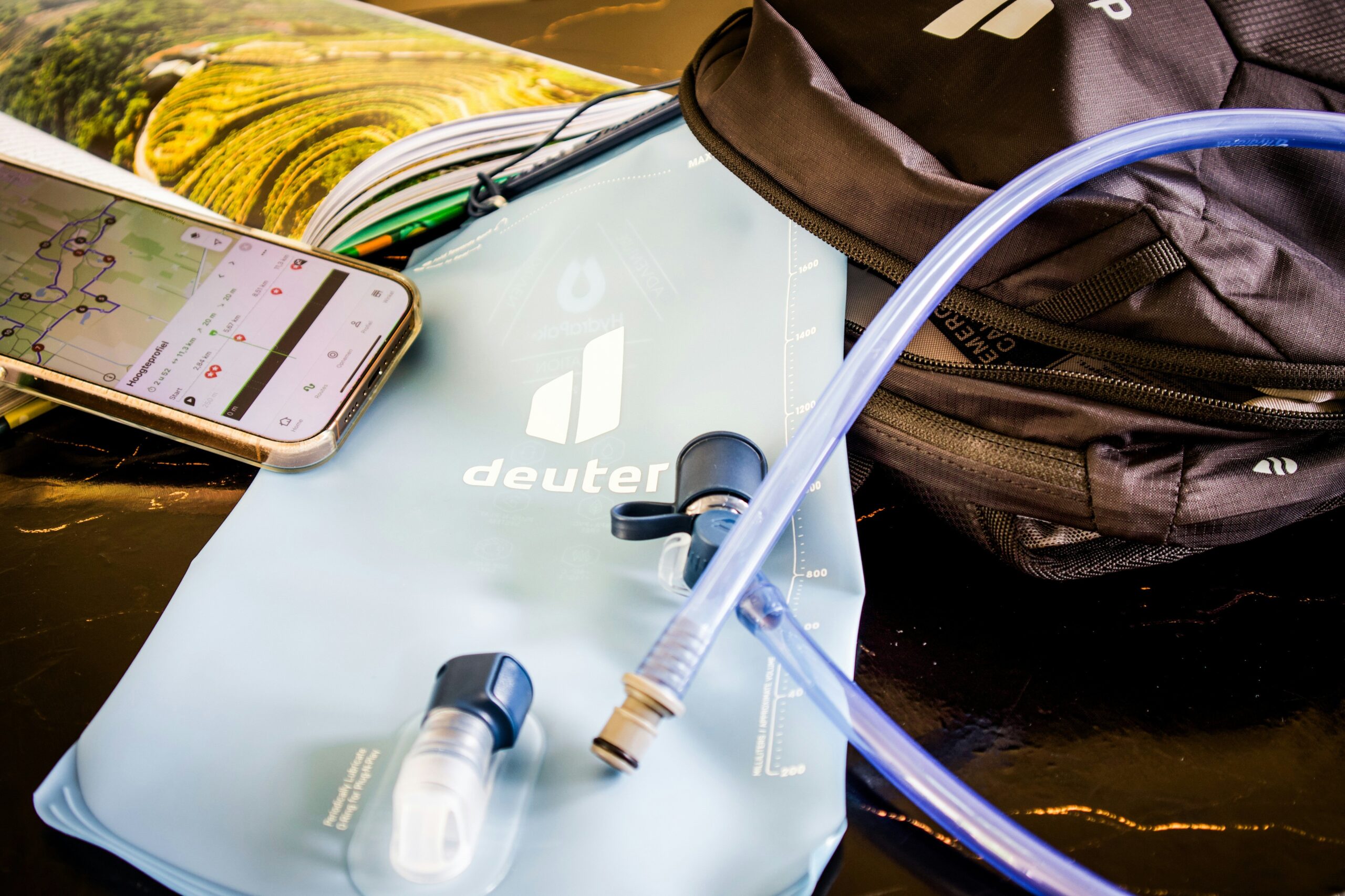 Backpack filled with helmet, water bottle, snacks, and tools