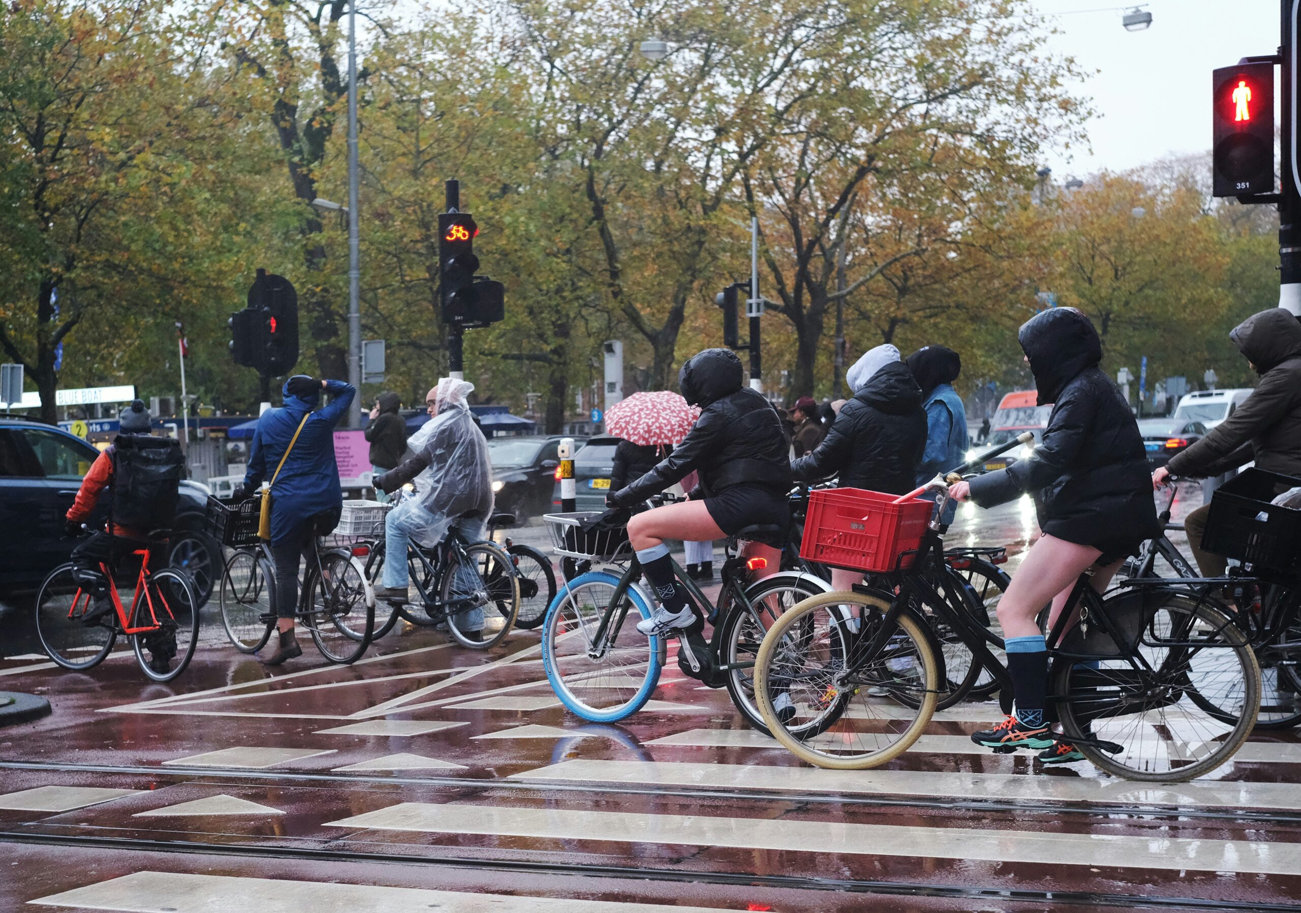 Cyclists crossing the iconic Brooklyn Bridge with Manhattan skyline in the background.
