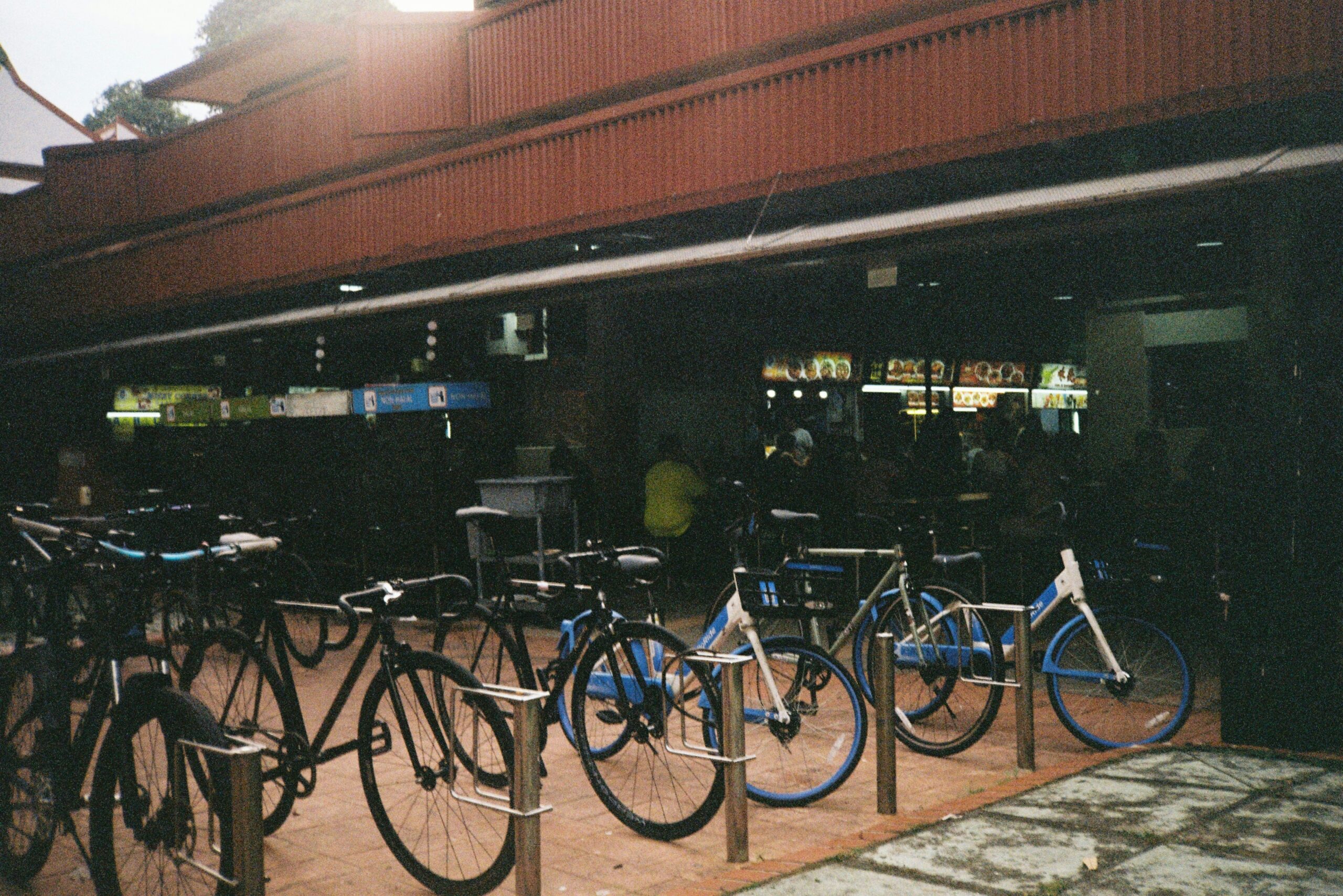 Interior view of a trendy cafe featuring bicycles mounted as wall art above cozy seating areas.