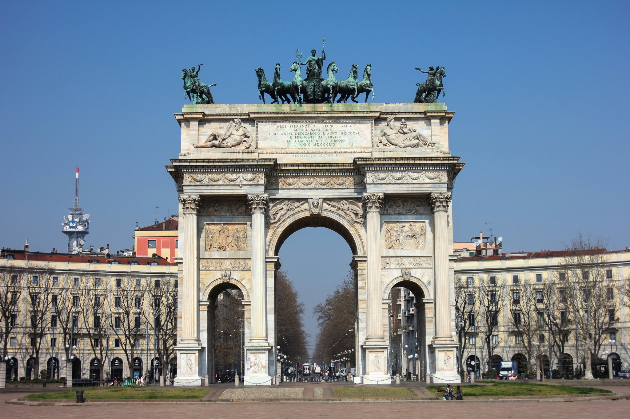 Close-up shot of a cyclist kneeling beside their ebike, fixing a flat tire on a rugged trail.