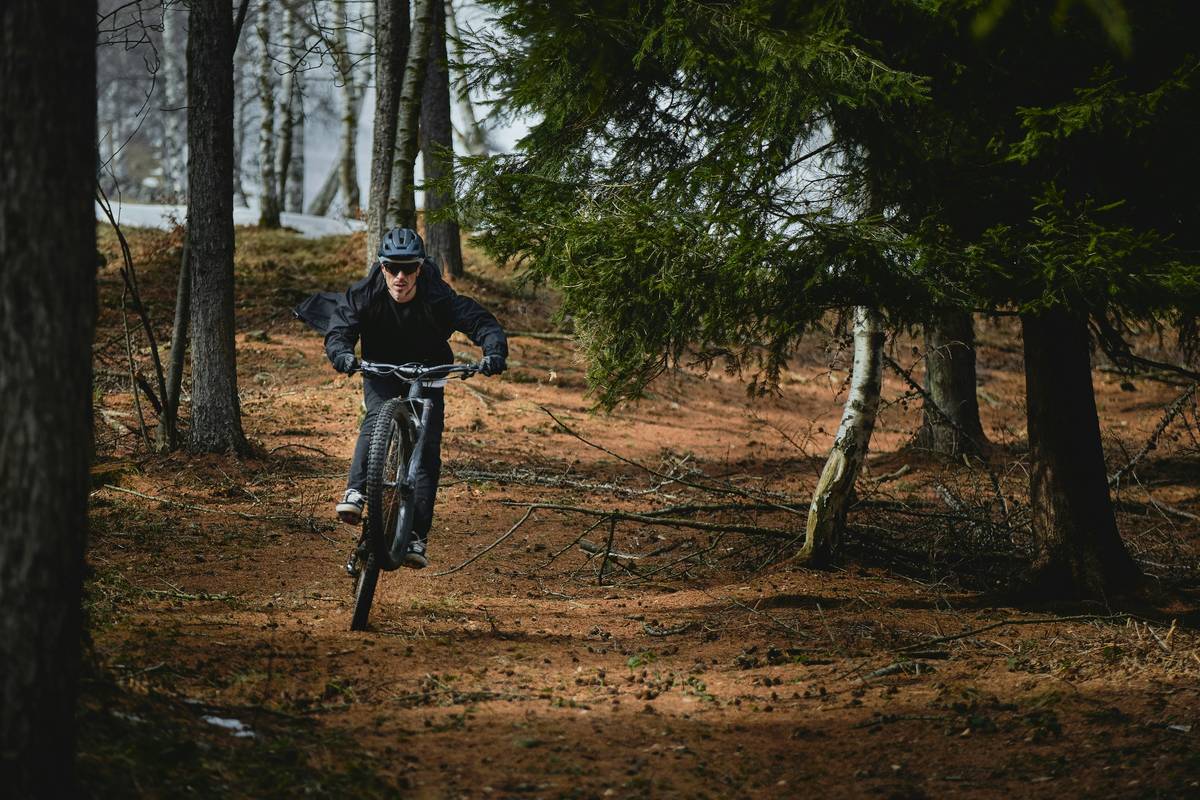 A guide helps a tourist adjust their helmet before embarking on a hill ebike excursion.