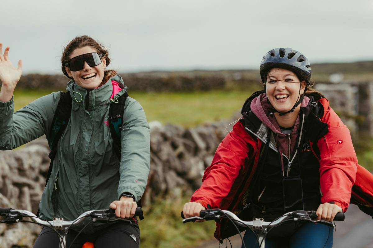 Close-up shot of a cyclist adjusting their helmet before tackling a steep slope.