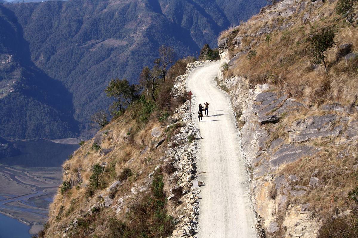 A cyclist riding an e-bike on a scenic forest trail.